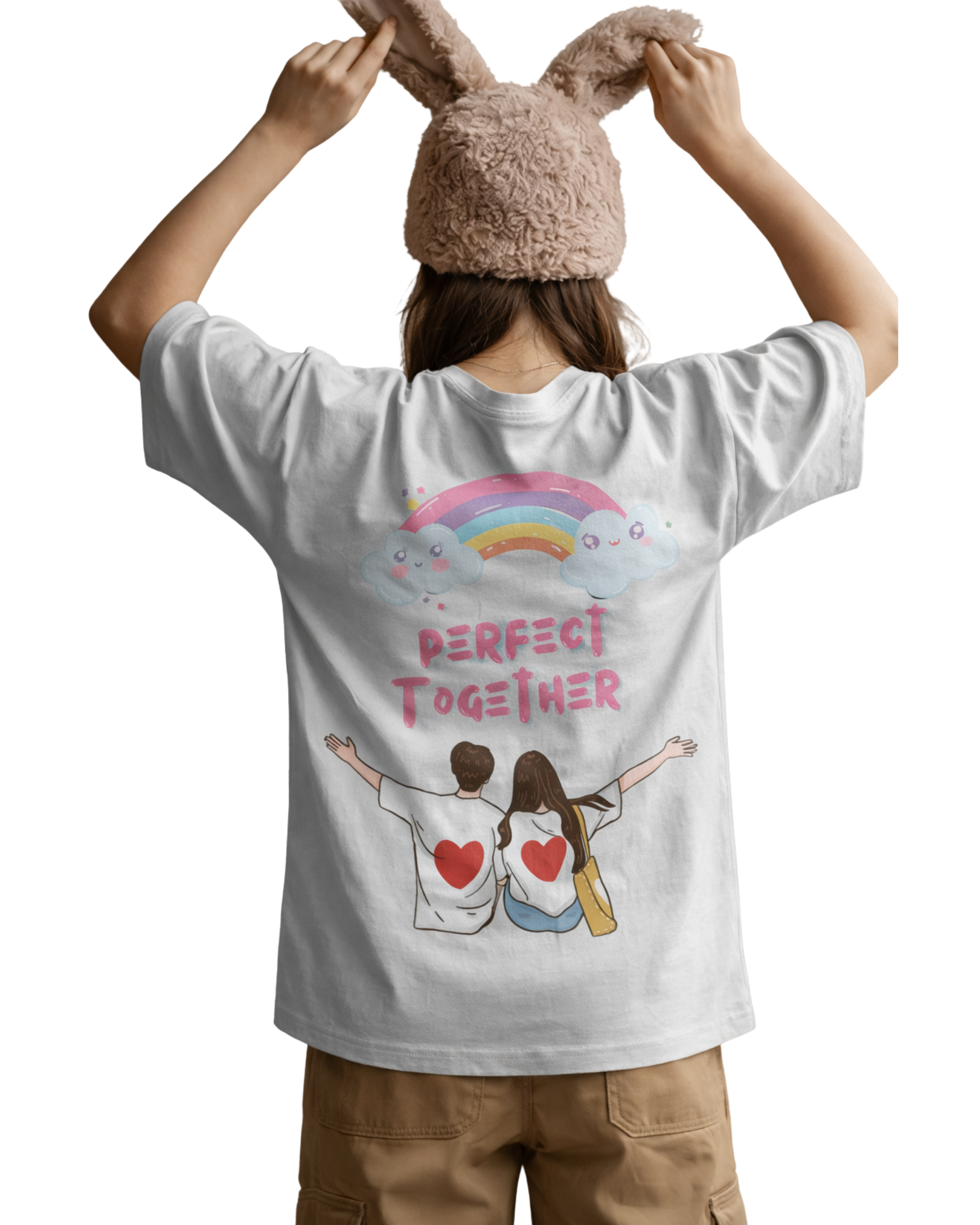 Person wearing a white t-shirt with a graphic design and text, holding a fluffy bunny hat.