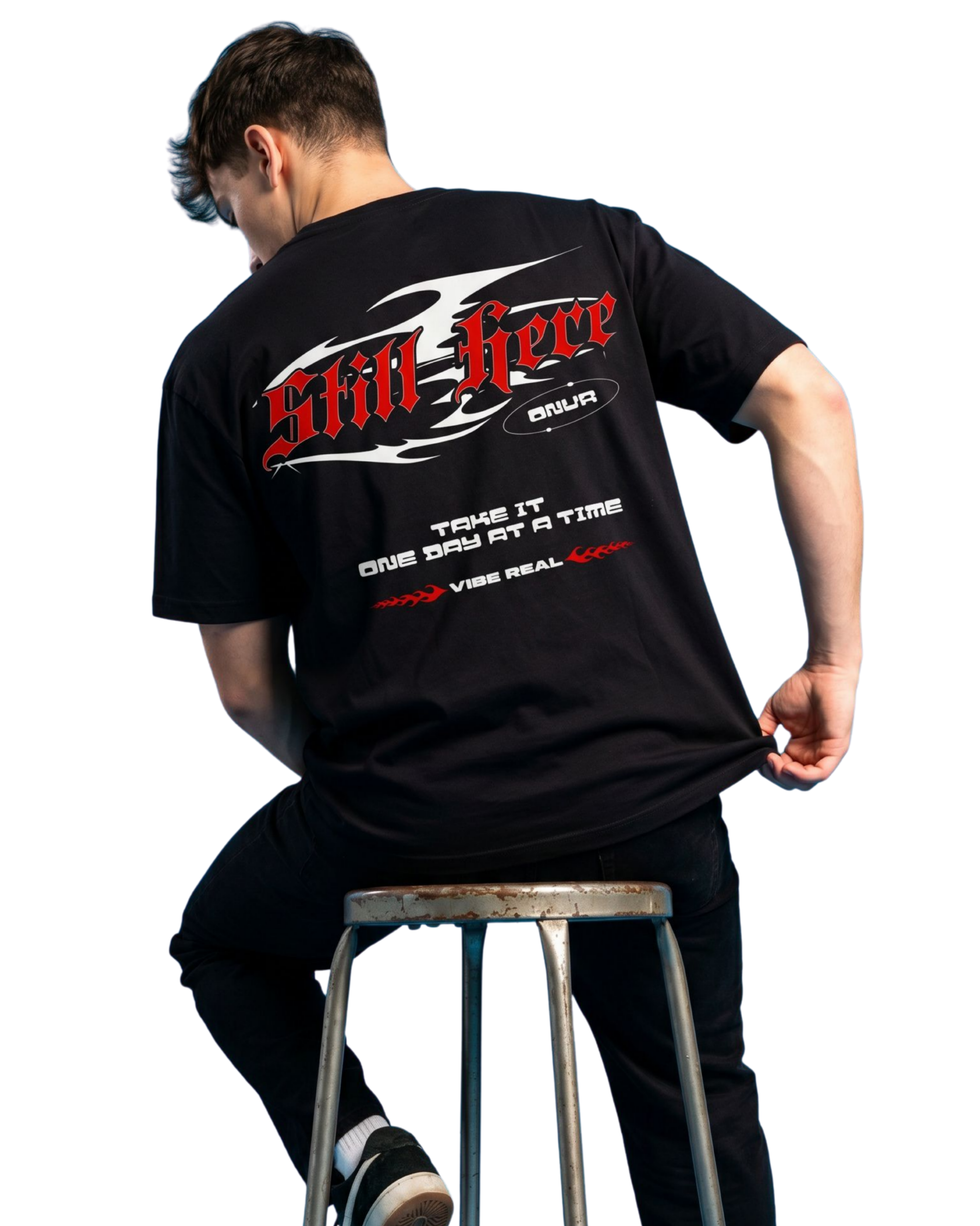 Person wearing a black t-shirt with red and white text sitting on a stool.
