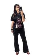 Person wearing a black t-shirt with a graphic design on a white background