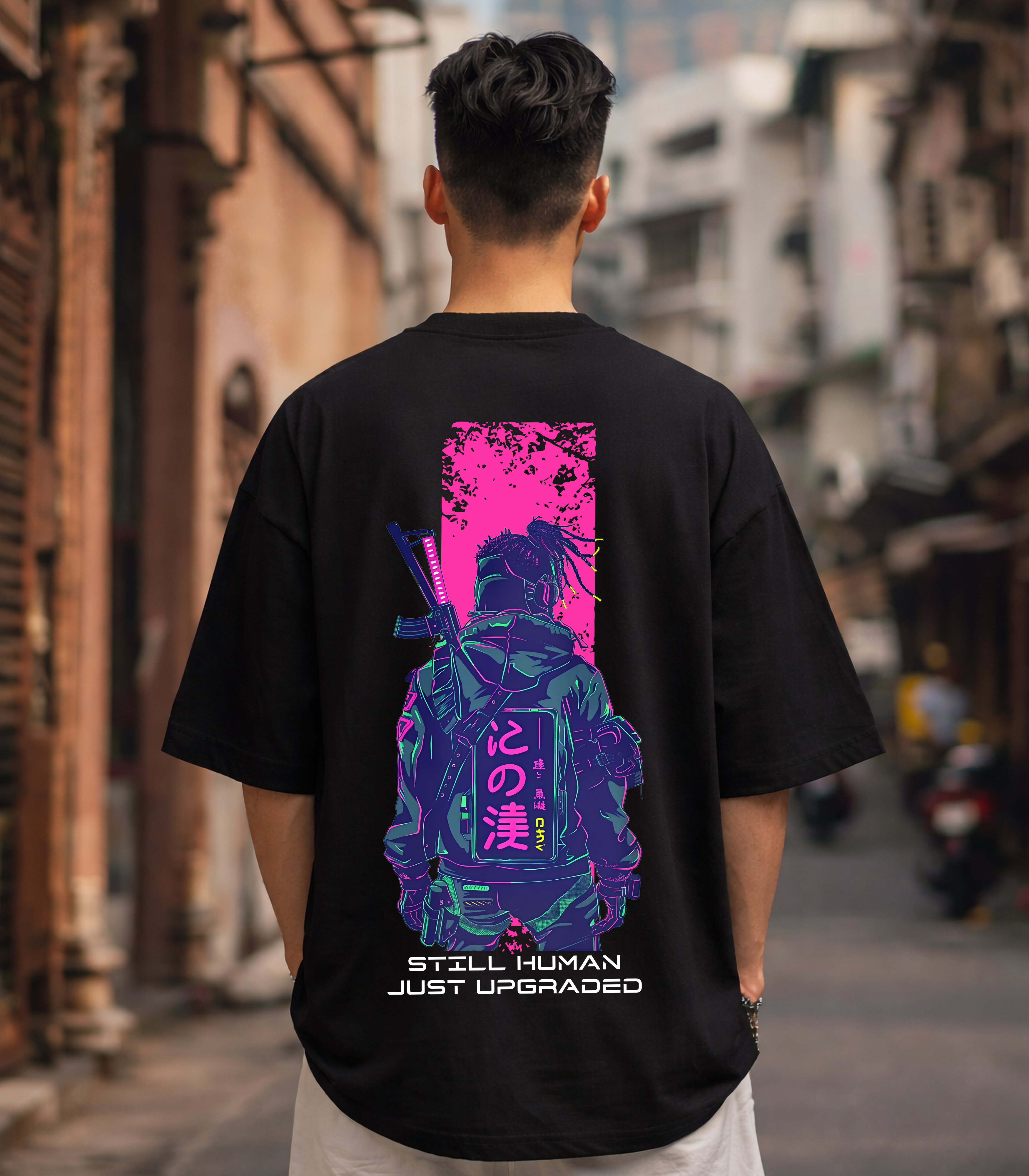 Person wearing a black t-shirt with a colorful graphic on the back in an urban setting
