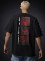 Model wearing a black t-shirt with red graphic design on the back against a dark background