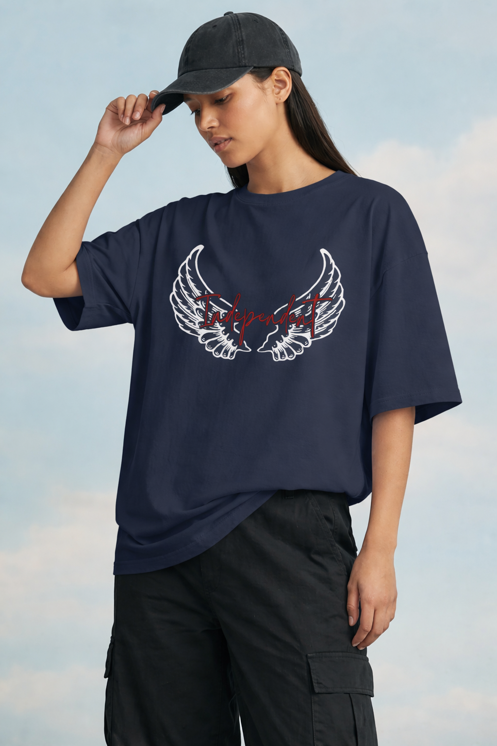 Person wearing a navy blue t-shirt with a graphic design against a cloudy sky background