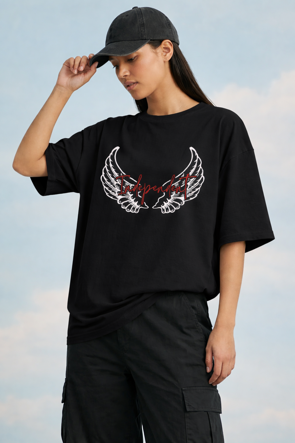 Person wearing a black t-shirt with a graphic design outdoors