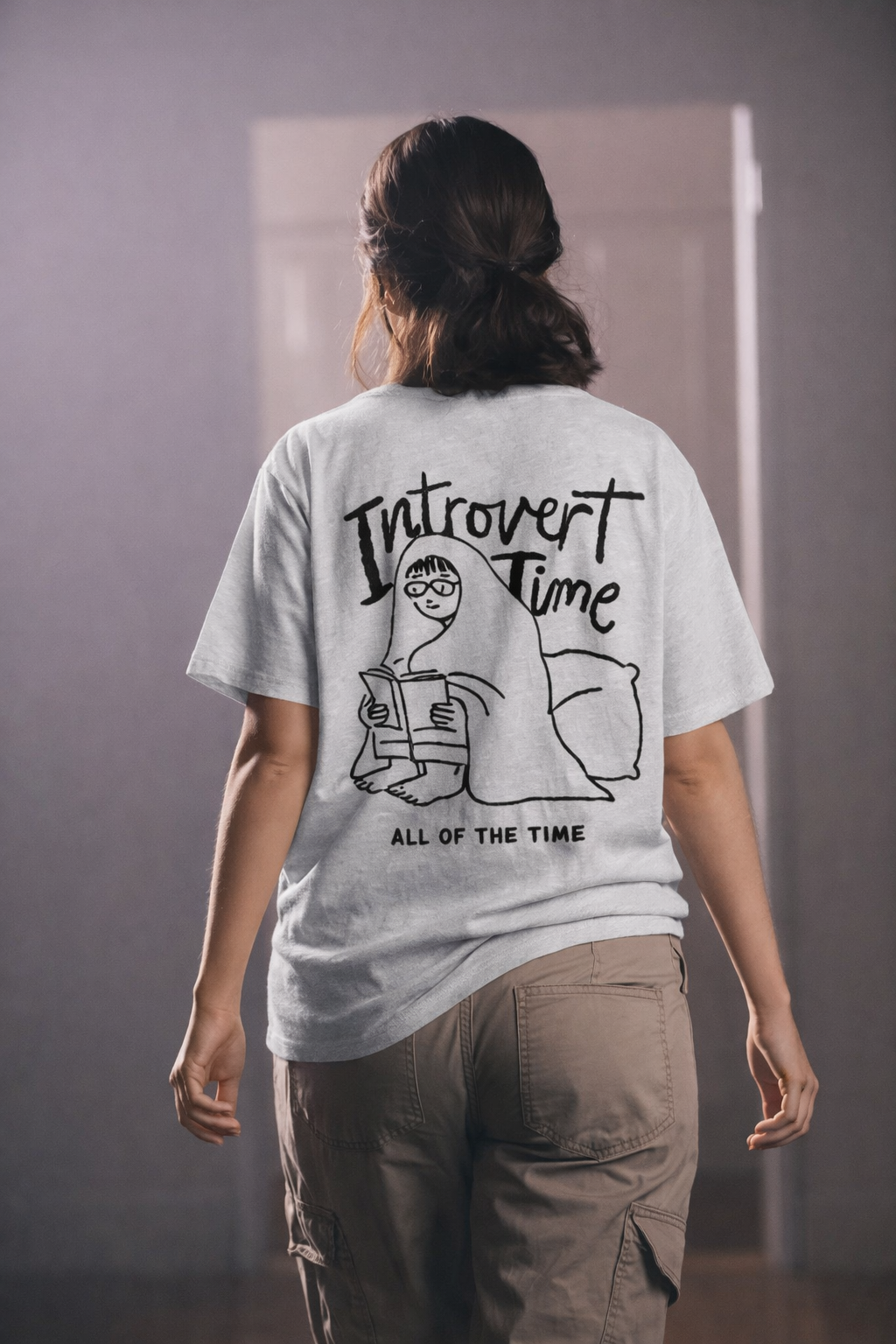 Person wearing a t-shirt with 'Introvert Time All of the Time' design.