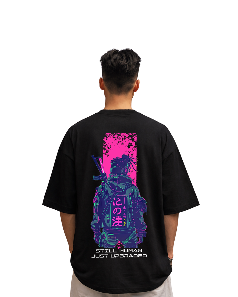 Model wearing a black t-shirt with a futuristic design on the back, featuring a character in a blue suit with pink and purple elements.