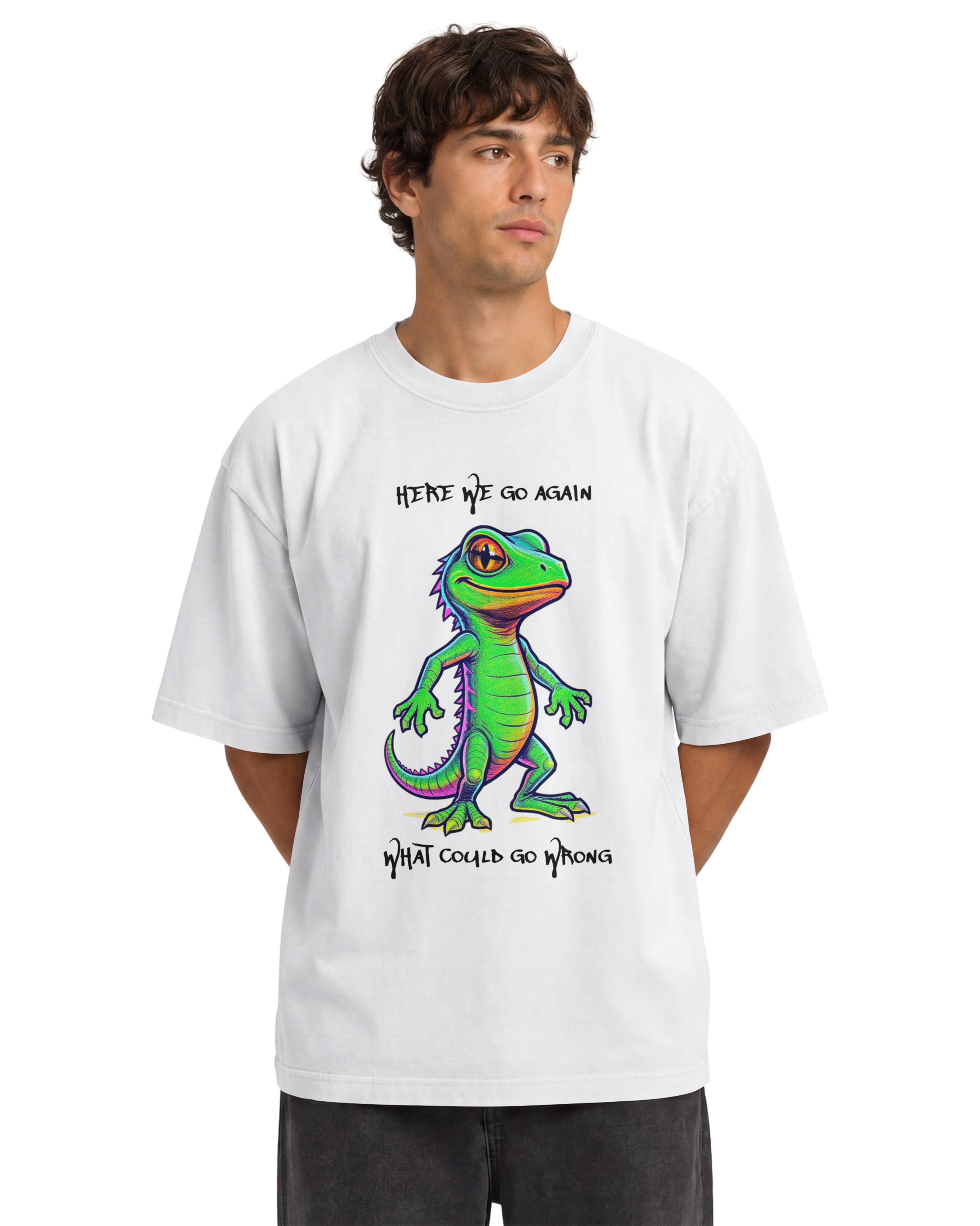 A man wearing a white short-sleeve ONVR t-shirt with a colorful cartoon green lizard graphic and the text 'HERE WE GO AGAIN' and 'WHAT COULD GO WRONG' on a plain white background.