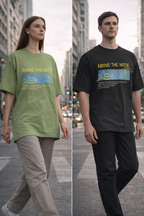 Two people wearing 'Above the Noise' t-shirts on a city street.