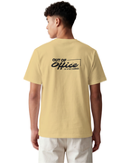 Person wearing a beige t-shirt with 'Out of Office' text on the back, standing against a white background