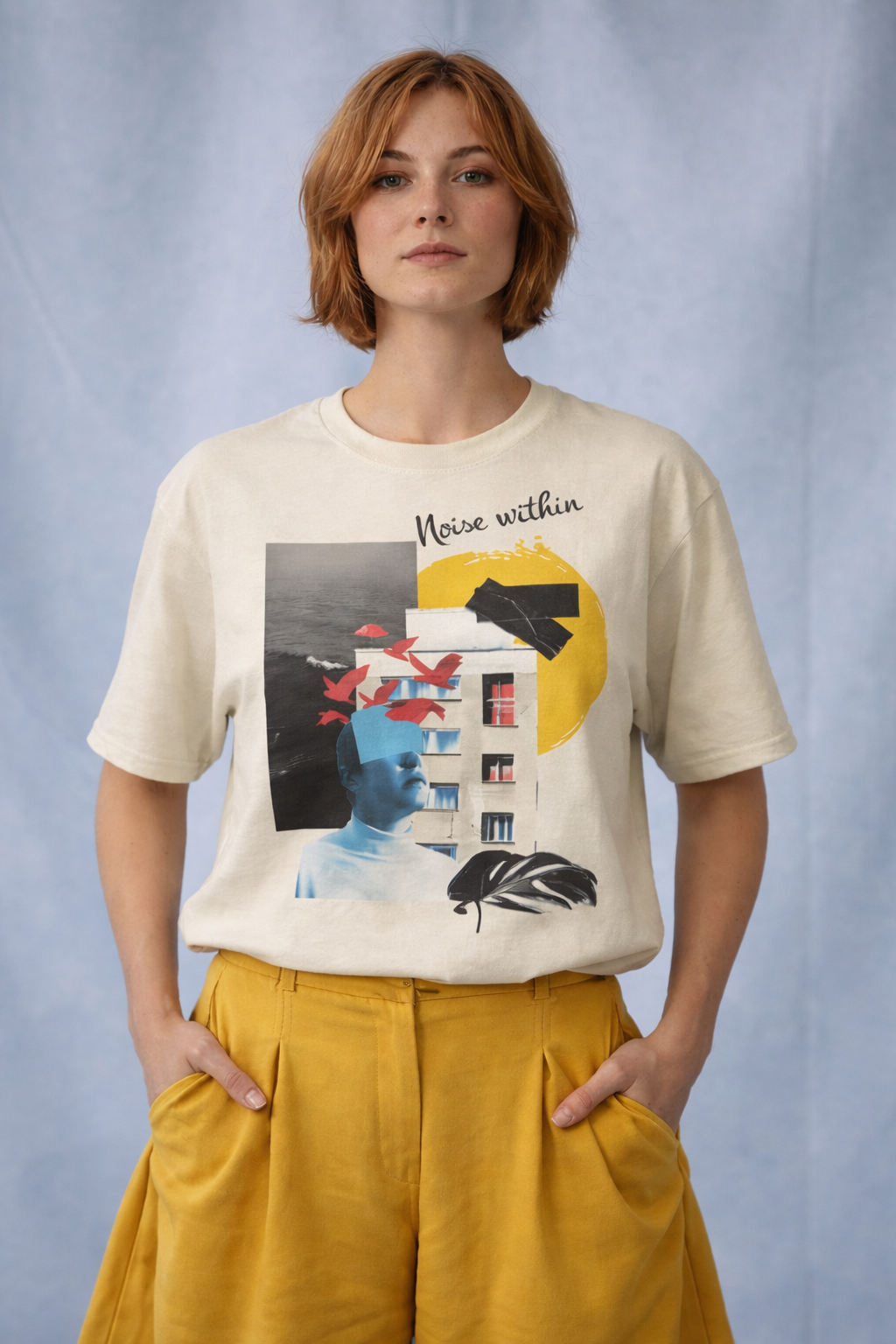 Person wearing a t-shirt with a graphic design and yellow pants against a light blue background